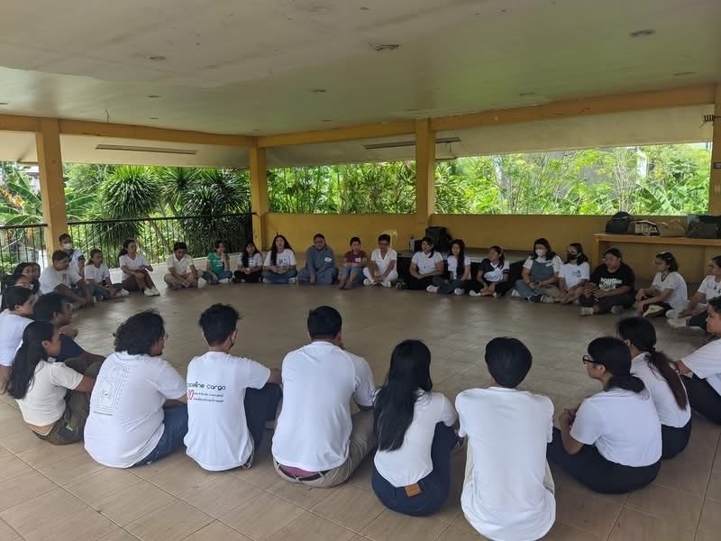 FC members seated in a circle for group facilitation
